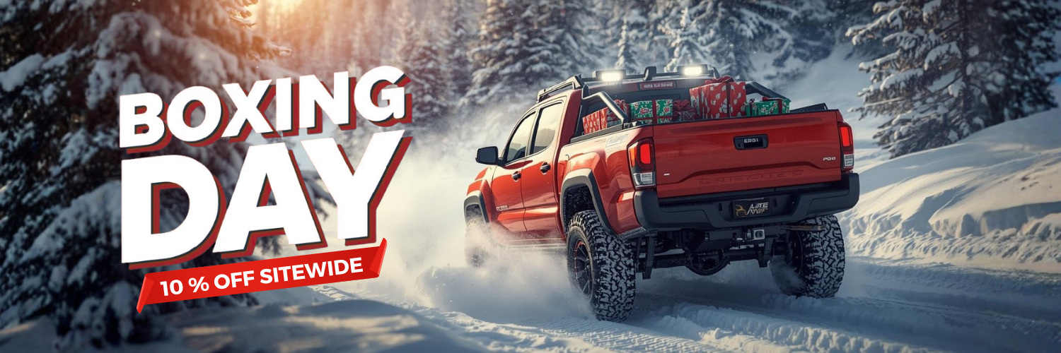 Red pickup truck in a snowy landscape with Boxing Day sale text overlay